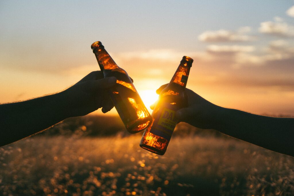 two people cheers with beers