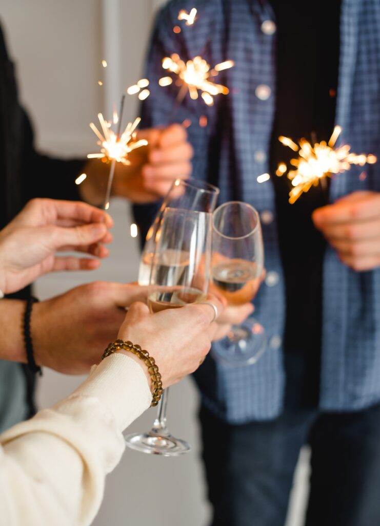 That's a photo of three people clinking champagne classes while setting off sparklers. Seems like a lot for a toast, but then again, I've never tried to do both at once!