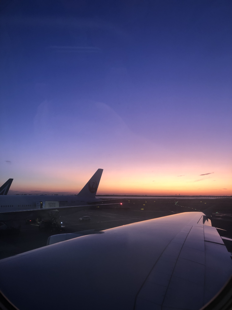 I took that photo from my window seat at JFK International Airport in New York City. The sun is setting as I headed out to Paris for work.