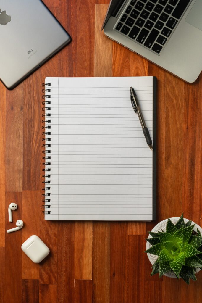 Here's an empty white spiral notebook on a brown desk.