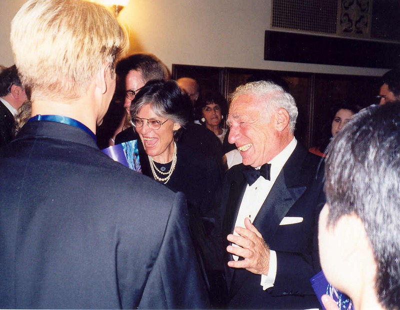 Mel Brooks, in a tuxedo, with his wife Ann Bancroft, talk with others at the 1997 Emmys.