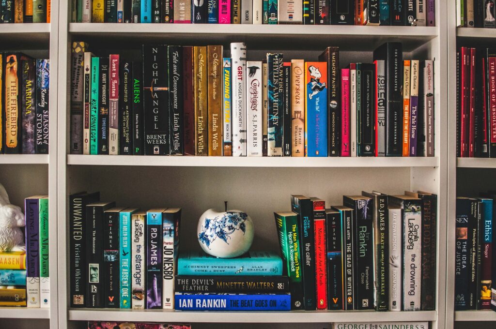 This is a photo of a bookshelf, stacked with books on all three shelves.