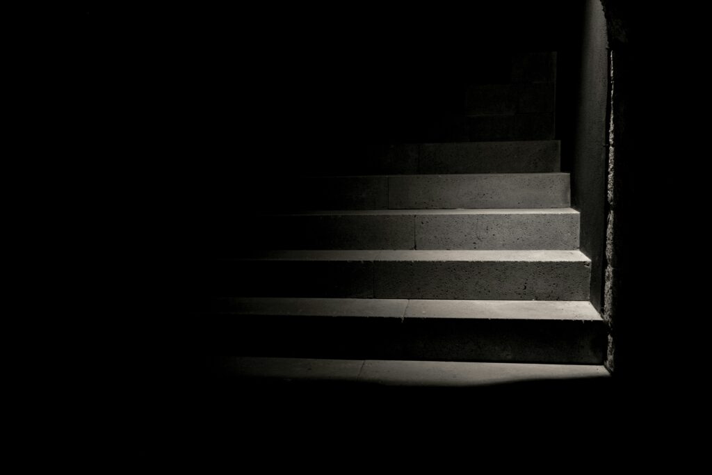 A splash of white light on an otherwise darkened staircase.