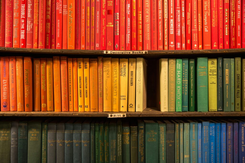 a rainbow of colors on a bookshelf