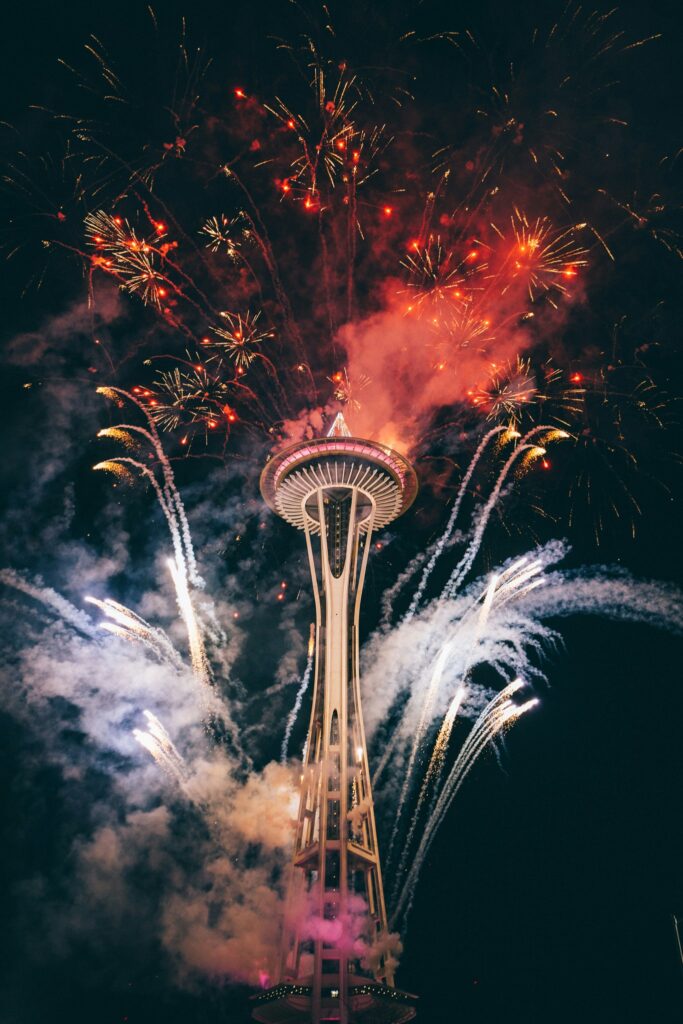 Fireworks and smoke, as seen from ground level looking up at the Space Needle in Seattle on New Year's Eve.